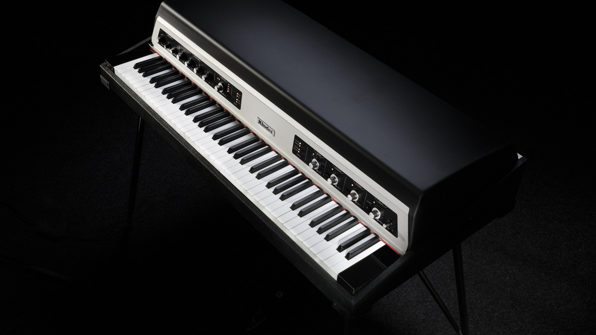 Rhodes MK8 Classic electric piano on chrome legs, lit against a dark background