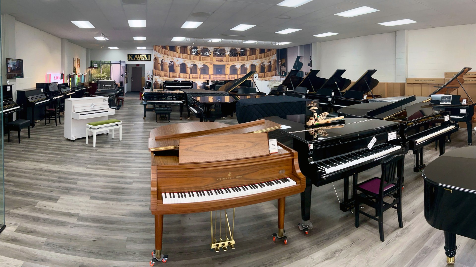 Interior of Pierre's Fine Pianos showroom in Los Angeles, filled with grand pianos
